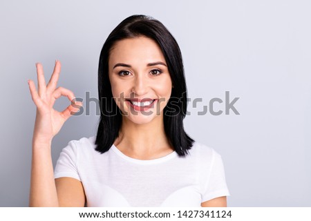 Close up photo beautiful amazing she her lady hand arm okey symbol perfect ideal appearance cheerful mood agreement opinion tested product wear casual white t-shirt isolated bright grey background