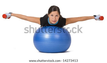 Young woman doing an exercise with barbells and a fitness ball