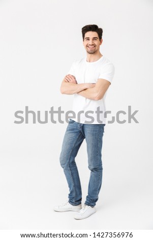 Image of a happy young excited emotional man posing isolated over white wall background.
