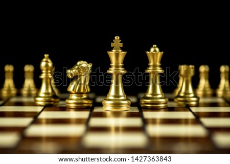 gold chess pieces on a chessboard, business strategy concept