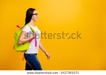 Close up side profile photo beautiful she her lady backpack going meet classmates groupmates before classes lessons wear specs casual white t-shirt jeans denim isolated bright yellow background
