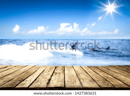 Wooden desk of free space and summer beach background. 