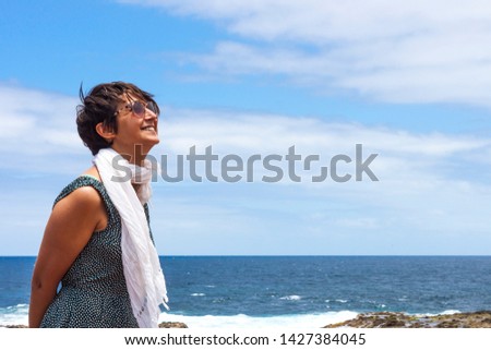 Beautiful model smiling with sunglasses in nature background