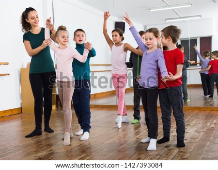 Glad children studying of partner dance  at dance school