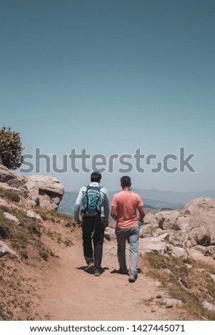 Two man tourist walk in a hill. stony hill, walking in nature, pure nature vacation , vertical photo.