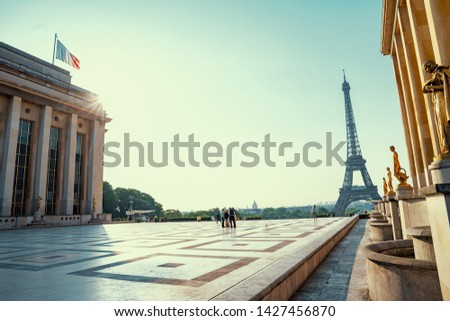 small paris street with view on the famous paris eifel tower on a cloudy rainy day with some sunshine Royalty-Free Stock Photo #1427456870