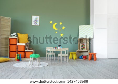Stylish interior of modern playroom in kindergarten Royalty-Free Stock Photo #1427458688