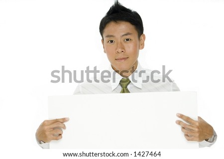 A young chinese businessman holding a blank signboard