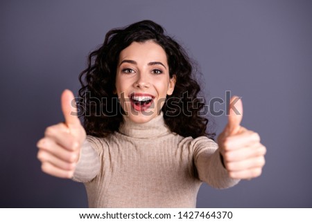 Close up photo attractive amazing she her lady volume hairstyle glad arms hands raised thumbs up symbol white teeth advising good job quality wear casual pastel pullover isolated grey background