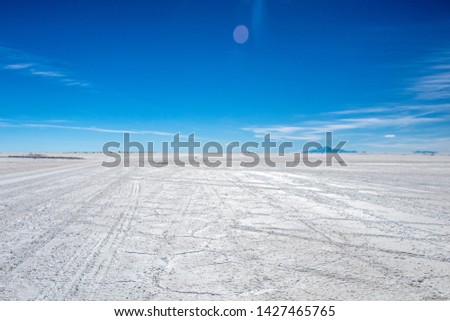 Landscape of incredibly white salt flat Salar de Uyuni, amid the Andes in southwest Bolivia, the world’s largest salt flat scene with blue sky in sunny day and Copy space