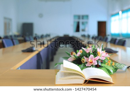 Close-up of open books on meeting table selective focus and shallow depth of field