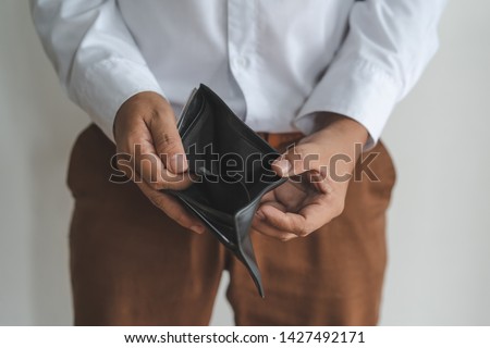 bankruptcy economic financial concept. Person open his empty wallet without money to pay debt in payday. Royalty-Free Stock Photo #1427492171