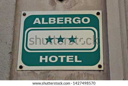 Italy: Signal of the Hotel with three stars (Albergo=Hotel).