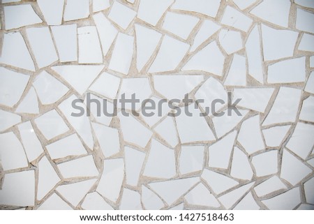 Broken white old tiles or tiles as interior design decoration. Old industrial rustic decor