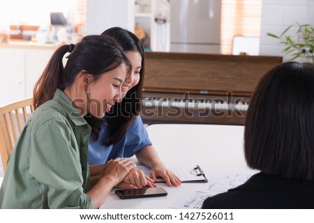 Happy asian lesbian couple sign contract for buy new house with realtor agent at new home after marry.LGBTQ lifestyle concept