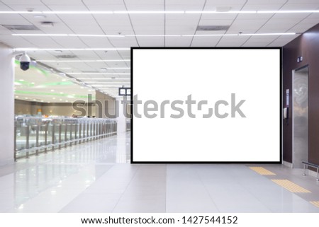 Blank white billboard black frame ad horizontal wall mounted in front of the passenger elevator in the airport terminal for public relations media, advertising, marketing. Space for text