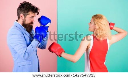 Gender equality. Man formal suit and athletic woman boxing fight. Couple in love competing in boxing. Female and male boxers fighting in gloves. Domination concept. Gender battle. Gender equal rights.