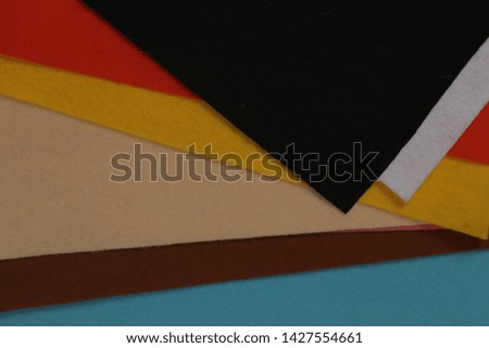 Images of multicolored felt fabric are stacked on top of each other . texture, background 