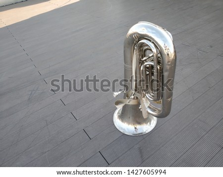 Large copper brass tuba instrument.