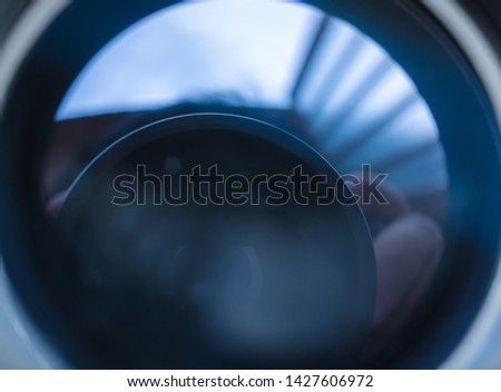 The reflection of the lens from the camera in the mirror