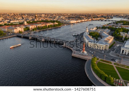 Aerial photo of center of Saint Petersburg at sunset, Russia, Old Stock Exchange building, Rostral columns, boats on the Neva river, bridges, Admiralty building, Isaac cathedral