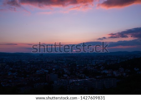 Colorful sunset on Bila Hora with beautiful view on city Brno, Czech Republic pink and orange colors with many clouds