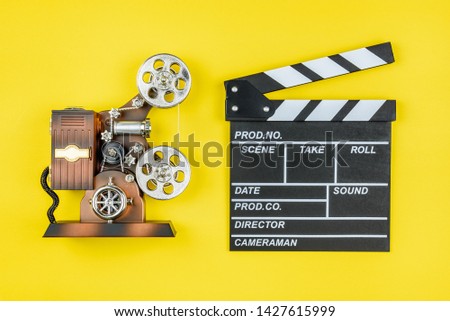 Film projector, movie shooting gear, clapperboard that used in filmmaking and video production to assist in synchronizing of picture and audio or sound, to designate and mark various scenes and takes