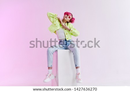 woman with pink hair sits on a cube fashion neon hairstyle