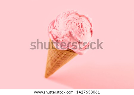 pink ice cream ball in a Waffle Cone on a pink Background. Fruit ice cream in a waffle cone. Royalty-Free Stock Photo #1427638061