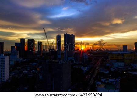 Building at the sunset with twilight sky blue purple background city landscape with long exposure car light and beautiful cloud