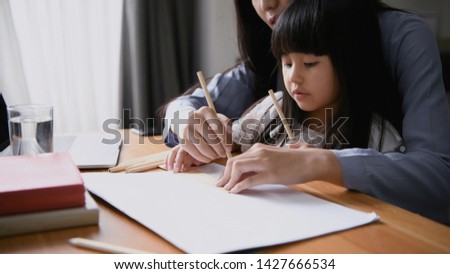 Family concept. Mom is teaching children to draw pictures.