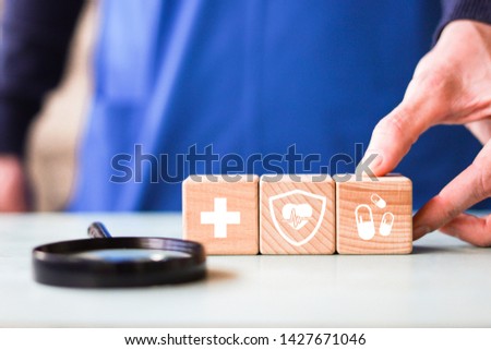 Doctor hand arranging wood block stacking with icon healthcare and medical, insurance and search for your health.