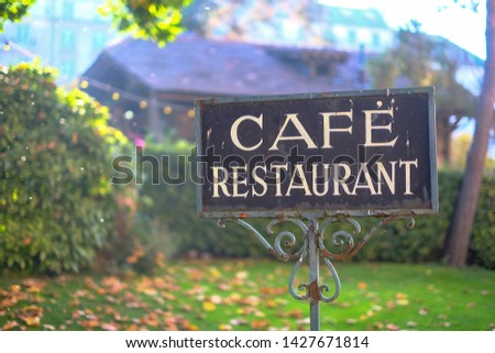 Cafe and Restaurant sign in a garden