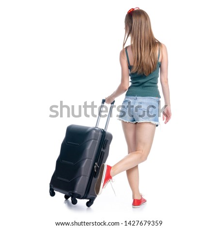 Woman with travel suitcase, sunglasses goes walking looking on white background isolation, back view