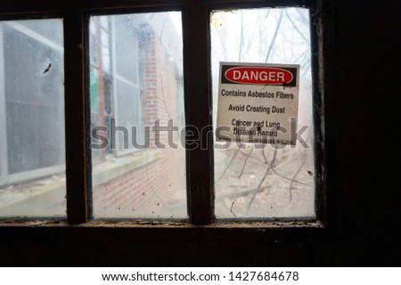Asbestos Warning Sign In an Abandoned Hospital Building                             