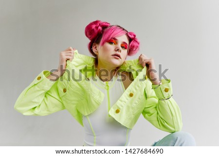 fashionable woman with pink hair in green jeans