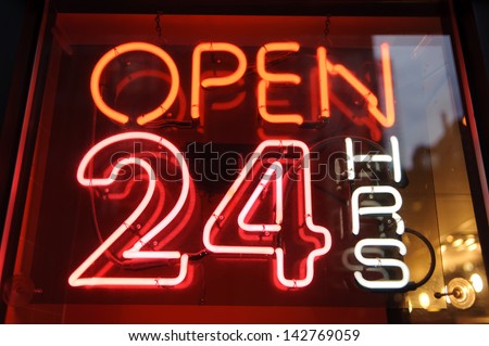 neon shining signboard with word "open 24" night