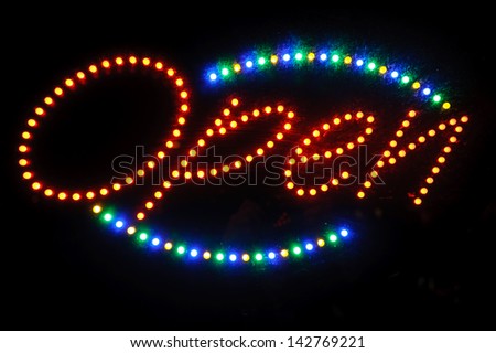 neon shining signboard with word "open" at night
