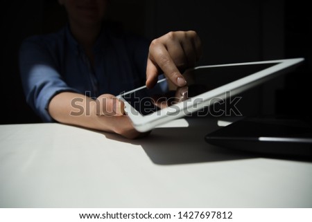 Unrecognizable woman working on Digital Tablet