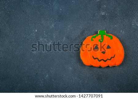 Halloween background. Holiday pumpkin gingerbread cookies on blue concrete background. Fall Autumn Concept. Top view, copy space