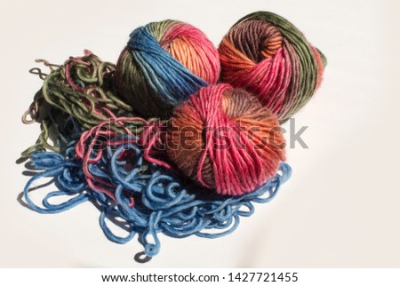 three balls of colorful yarn