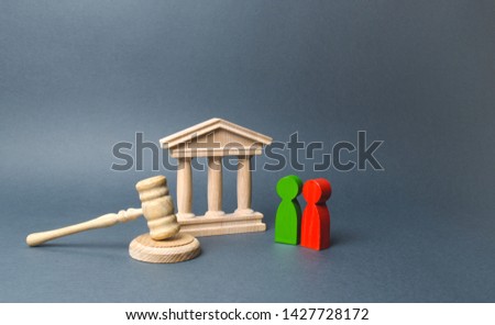 Two figures of people opponents stand near the courthouse and the judge's gavel. The judicial system. Conflict resolution in court, claimant and respondent. Court case, settling disputes. Royalty-Free Stock Photo #1427728172