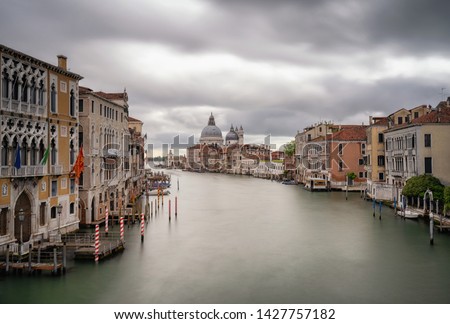 Grand Canal view in Venice, Italy. Long exposure photography of a cloudy sky. Can see the Basilica di Santa Maria della Salute 