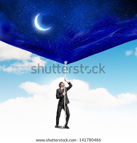 Image of businessman pulling banner with illustration. Day and night concept
