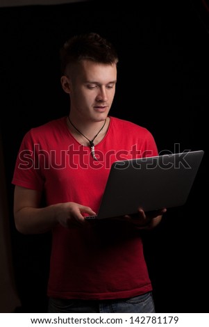 Portrait of a handsome young man with a laptop