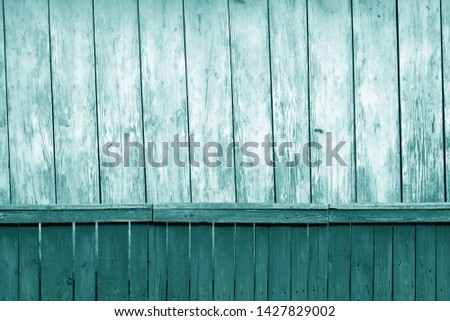 Old grunge wooden fence and wooden wall pattern in cyan tone. Abstract background and texture for design.