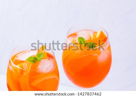 Aperol Spritz cocktail with mint leaves on a white background. Italian cocktail aperol spritz on white