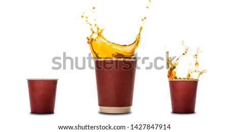 Disposable paper cups with coffee splash isolated on white. Concept: coffee advertising