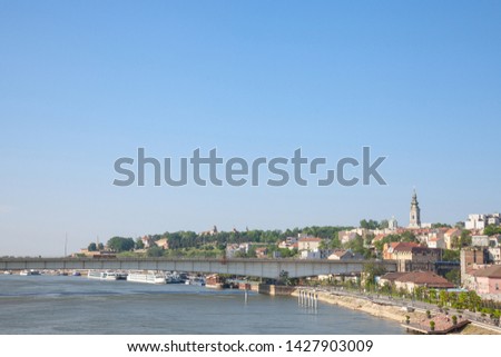 View of Sava river bank in Belgrade. An orthodox cathedral church can be seen on the right, Kalemegdan fortress on the background, and brankov most bridge in front

