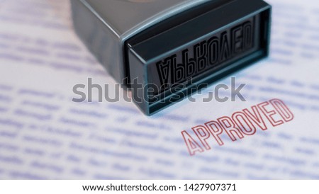 Document that has been stamped printed on Approved in large diagonal red text and rubber stamp, Business credit concept